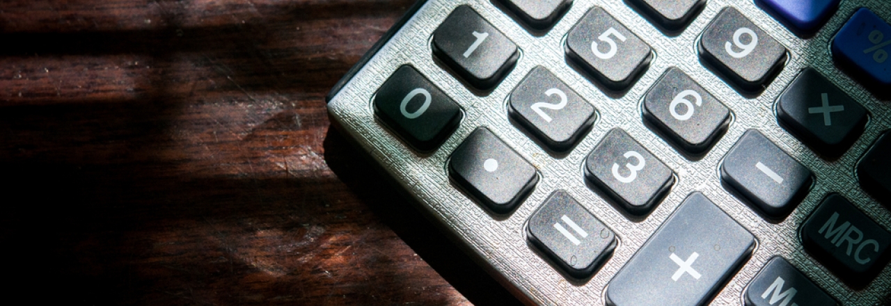 Close-up of Calculator on Wooden Table